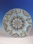 AN 18th C. ENGLISH DELFT POLYCHROME PLATE WITH CENTRAL AUBERGINE FLORAL SPOKED WHEEL DESIGN