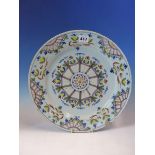 AN 18th C. ENGLISH DELFT POLYCHROME PLATE WITH CENTRAL AUBERGINE FLORAL SPOKED WHEEL DESIGN