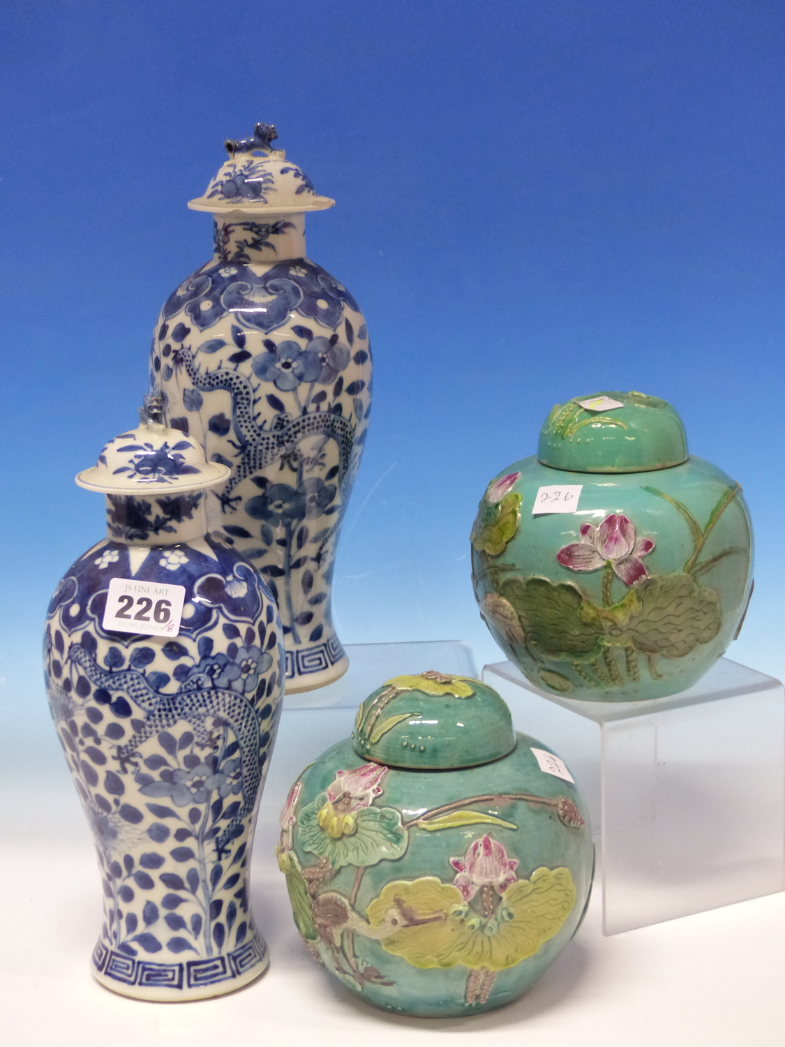 A PAIR OF CHINESE BLUE AND WHITE BALUSTER VASES AND COVERS PAINTED WITH DRAGONS AMONGST FOLIAGE,