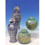 A PAIR OF CHINESE BLUE AND WHITE BALUSTER VASES AND COVERS PAINTED WITH DRAGONS AMONGST FOLIAGE,