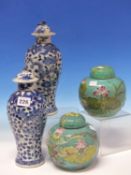 A PAIR OF CHINESE BLUE AND WHITE BALUSTER VASES AND COVERS PAINTED WITH DRAGONS AMONGST FOLIAGE,