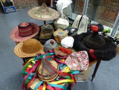 A COLLECTION OF SEVENTEEN HATS LABELLED FOR THEIR ORIGINS IN THE WORLD AND DATED FOR WHEN THEY