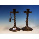 A PAIR OF GOBERG (HUGO BERGER) IRON CANDLESTICKS WITH SNUFFERS CHAINED TO THE CRENELLATED DRIP PANS,