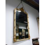 AN ANTIQUE FRENCH PAINTED AND GILT OVERMANTLE /PIER MIRROR. SHAPED BEVELLED PLATE. 180 x 110cms.