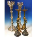 A PAIR OF NEOGOTHIC SILVERED PRICKET CANDLESTICKS. H 48.5cms. A PAIR OF PARCEL GOLD PAINTED BRASS