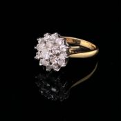 AN 18CT YELLOW GOLD AND TRIPLE TIER DIAMOND CLUSTER RING. SET WITH NINETEEN ROUND BRILLIANT CUT