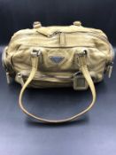 PRADA HANDBAG. A TWO TONE PALE VINTAGE LEATHER HANDBAG. BEIGE LEATHER INTERIOR WITH ZIP POCKET,