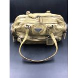 PRADA HANDBAG. A TWO TONE PALE VINTAGE LEATHER HANDBAG. BEIGE LEATHER INTERIOR WITH ZIP POCKET,