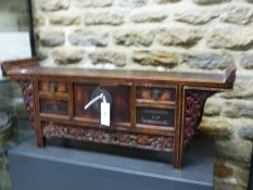 A CHINESE MINIATURE ALTAR TABLE, THE RECTANGULAR TOP WITH RAISED NARROW ENDS ABOVE CENTRAL DOORS