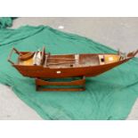 A MAHOGANY SCALE MODEL OF A CHINESE SAILING JUNK ON WOOD STAND. W 84cms.