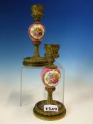 A PAIR OF BRONZE AND PORCELAIN CANDLESTICKS, THE ROSE POMPADOUR GROUND KNOPS EACH PAINTED WITH TWO