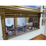 AN EARLY 19th C. THREE PLATE MIRROR, THE GILT FRAME WITH VINE ENTWINED COLUMN TO THE TOP AND