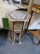 AN ISLAMIC HEXAGONAL TABLE GEOMETRICALLY INLAID IN BONE AND MOTHER OF PEARL, H. 57cms.