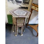 AN ISLAMIC HEXAGONAL TABLE GEOMETRICALLY INLAID IN BONE AND MOTHER OF PEARL, H. 57cms.