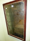 A GEORGE III RECTANGULAR MIRROR WITHIN FOLIATE GILT SLIP AND MAHOGANY FRAME. 67 x 41cms.