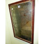 A GEORGE III RECTANGULAR MIRROR WITHIN FOLIATE GILT SLIP AND MAHOGANY FRAME. 67 x 41cms.