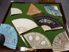 A COLLECTION OF EIGHT FANS, TO INCLUDE: FOUR WITH CARVED IVORY STICKS, THREE WITH PAINTED LEAVES AND