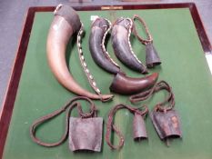 THREE COWRIE DECORATED COWS HORNS, ANOTHER UNDECORATED,A COWS HORN BELL TOGETHER WITH THREE IRON COW