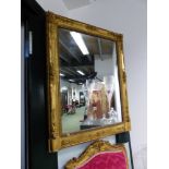 A FRENCH 19th.C. RECTANGULAR MIRROR WITHIN A GILT FRAME CARVED WITH FLOWERS AT THE CORNERS AND