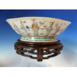 A 19th C. CANTON QUATREFOIL BOWL AND WOOD STAND, THE EXTERIOR PAINTED WITH DAOIST IMMORTALS. W 26.