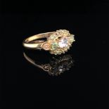 A 9ct GOLD GREEN AND CHAMPAGNE GEMSTONE DRESS RING, FINGER SIZE N, WEIGHT 3.1grms.