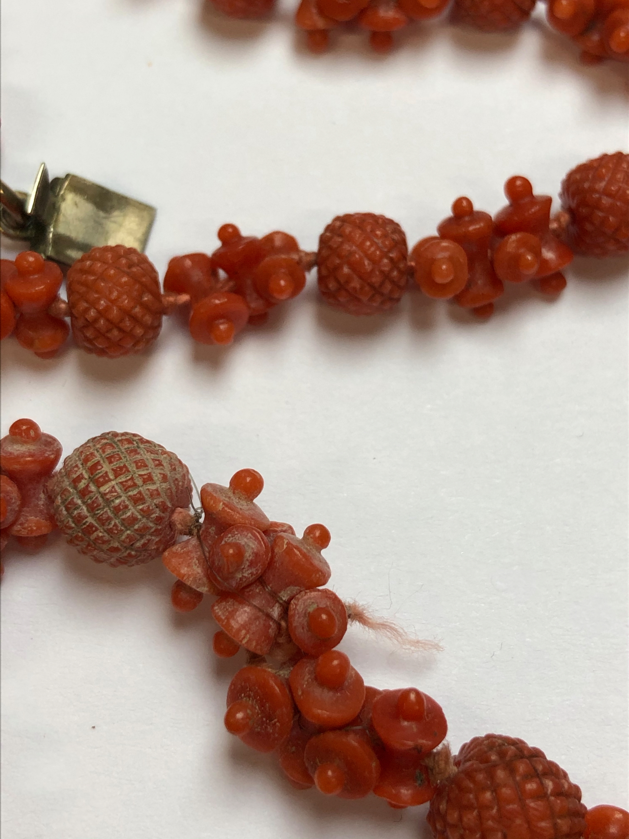 AN ANTIQUE CARVED RED CORAL ROPE OF BEADS AND SPACERS, COMPLETE WITH AN ENGRAVED BOX CLASP. APPROX - Image 11 of 31