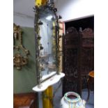 A FRENCH STYLE PIER GLASS AND TABLE, THE EIGHT MIRROR PLATES WITH ROUND ARCH TOP AND WITHIN A GILT