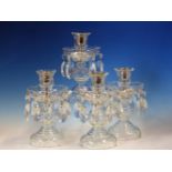 A SET OF FOUR CLEAR GLASS LUSTRE CANDLESTICKS. H 20cms.