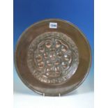 AN ARTS AND CRAFTS COPPER DISH WORKED WITH A CENTRAL TUDOR ROSE, THE BACK WITH A SUSPENSION LOOP.