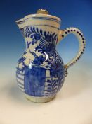 AN 18th C. DUTCH DELFT BLUE AND WHITE JUG AND COVER PAINTED WITH TWO GARDEN SCENES EITHER SIDE OF