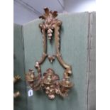 A PAIR OF FRENCH STYLE GILT BRONZE FOUR BRANCH WALL LIGHTS, THE NOZZLES ON ARMS SCROLLING BAROQUE