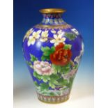 A CHINESE CLOISONNE ENAMEL MEIPING WORKED WITH BIRDS AMONGST PEONIES BELOW MAGNOLIA ON A BLUE