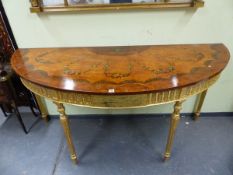 A GEORGE III STYLE DEMILUNE CONSOLE TABLE WITH CROSS BANDED MAHOGANY TOP, THE GILT APRON WITH