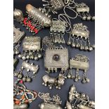 A LARGE AFRICAN SILVER PRAYER BOX, INSET WITH A CABOCHON HARDSTONE, STRUNG WITH METAL BELLS,