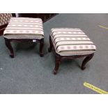 A PAIR OF LOUIS XV STYLE OAK LOW STOOLS CARVED WITH FLOWER HEADS CENTRAL TO THE APRONS AND ON THE