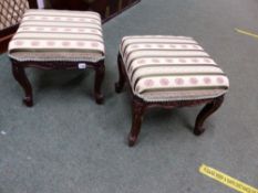 A PAIR OF LOUIS XV STYLE OAK LOW STOOLS CARVED WITH FLOWER HEADS CENTRAL TO THE APRONS AND ON THE