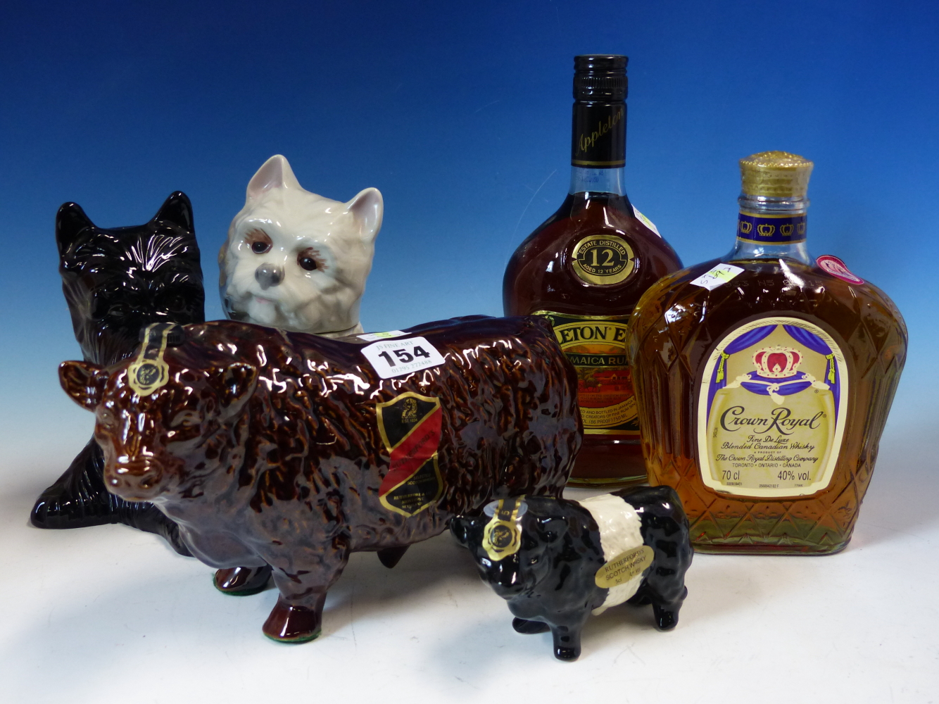 WHISKY, A 70CL BOTTLE OF CROWN ROYAL WHISKY, RUTHERFORDS WHISKY WITHIN A BULL SHAPED CONTAINER AND A