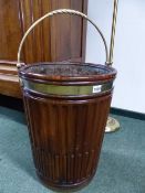 A PAIR OF GEORGIAN STYLE MAHOGANY PEAT BUCKETS AND LINERS, EACH OVERSWUNG BY BRASS HANDLES, THE