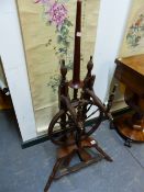 A 19th C. OAK SPINNING WHEEL WITH TREADLE TURNING TWELVE SPOKE WHEEL