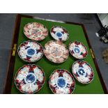 A PAIR OF FUKUGAWA IMARI FLUTED PLATES WITH CENTRAL VASES OF FLOWERS, SPIDER MARKS. Dia. 24cms.