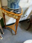 A PAIR OF FRENCH STYLE VARIEGATED BLACK MARBLE TOPPED TRIANGULAR TABLES WITH GILT WHITE APRONS AND