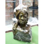 NICHOLAS TANDI (BORN 1949), A GREEN STONE BUST OF A SHONA MAN, THE TOP OF HIS HAT AND HIS CHEST IN