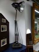 A FLOOR STANDING BLACK ANGLEPOISE GIANT 1227 LAMP ON STEPPED SQUARE FOOT LABELLED 205/250, THE RIM