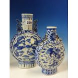 TWO 19th C. CHINESE BLUE AND WHITE MOON FLASKS, THE TALLER PAINTED WITH ROUNDELS OF DRAGONS. H