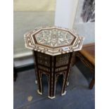 AN ISLAMIC HEXAGONAL TABLE GEOMETRICALLY INLAID IN BONE AND MOTHER OF PEARL. H. 50cms.