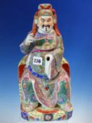 AN ENTHRONED FIGURE OF A MAN, POSSIBLY WENCHANG WANG, HE SITS ON A TIGER SKIN, POINTS WITH HIS RIGHT