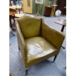 A GREEN LEATHER COVERED ARMCHAIR, THE SERPENTINE TOP RAIL AND ARM TOPS CLOSE NAILED, THE SQUARE