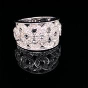 A 9ct WHITE GOLD DIAMOND SET OPEN WORK RING WITH GRADUATED DIAMOND SET CIRCLES. FINGER SIZE O.