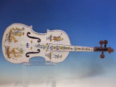 A MOUSTIERS FAIENCE MODEL OF A VIOLIN PAINTED WITH THREE MUSICIANS, A BOWMAN AND FLOWERS, SIGNED.