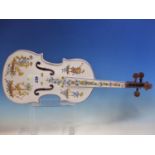A MOUSTIERS FAIENCE MODEL OF A VIOLIN PAINTED WITH THREE MUSICIANS, A BOWMAN AND FLOWERS, SIGNED.